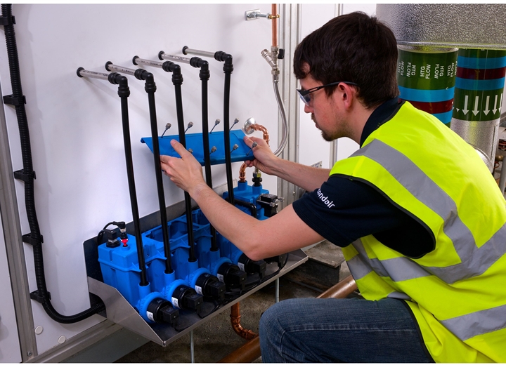 Technician fixing multi-stage pump system on humidifier 