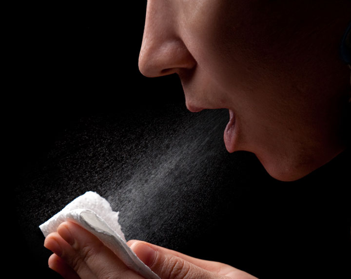 coughing with saliva and humidity droplets visible