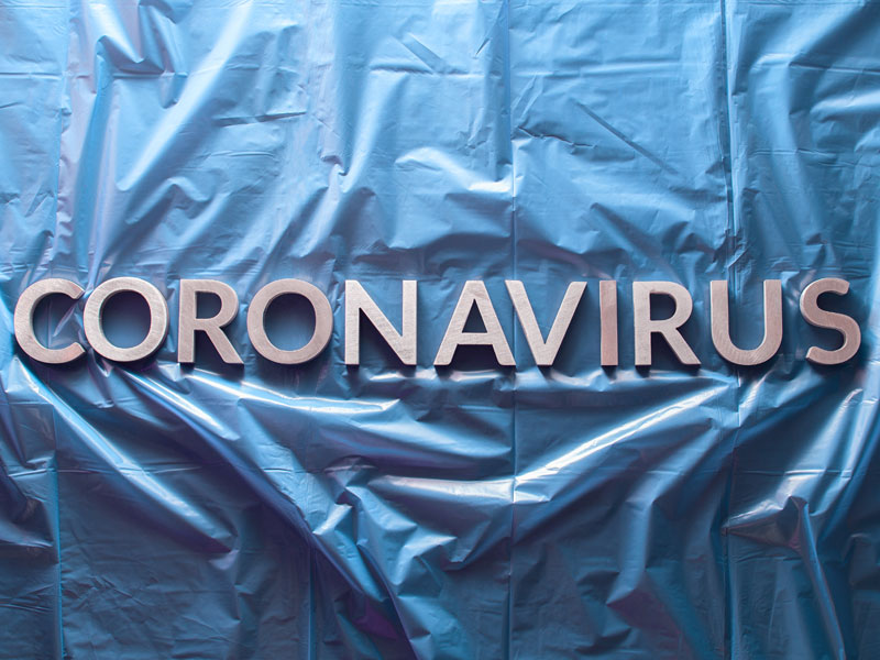 Coronavirus written across blue tarp