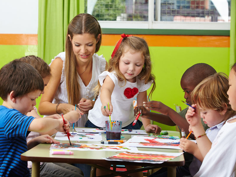 Children painting at table
